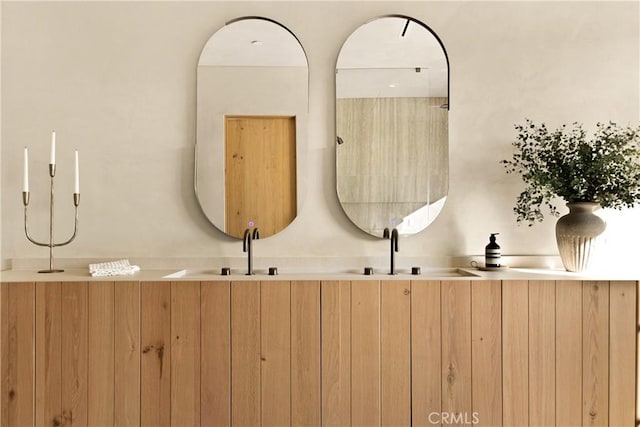 bathroom with a sink and double vanity