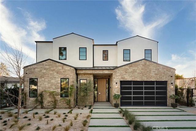 contemporary house featuring fence, stucco siding, driveway, and stone siding