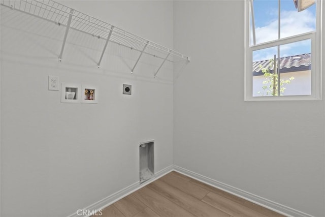 laundry area featuring baseboards, washer hookup, wood finished floors, hookup for an electric dryer, and laundry area