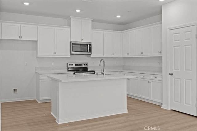 kitchen featuring light countertops, white cabinets, and appliances with stainless steel finishes