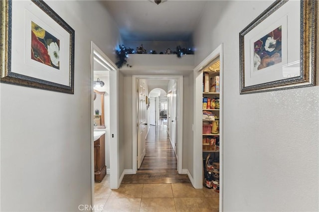 20130 Monte Vista Rd, Apple Valley, CA 92308 - hallway featuring arched walkways, light tile patterned floors, and baseboards