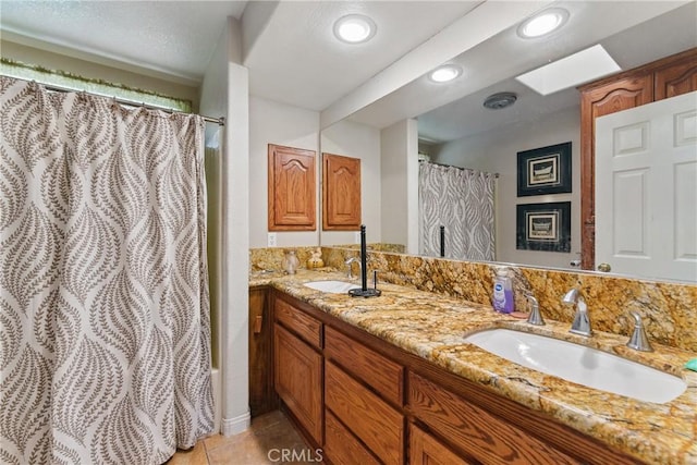 20130 Monte Vista Rd, Apple Valley, CA 92308 - bathroom featuring a sink, double vanity, curtained shower, and tile patterned flooring