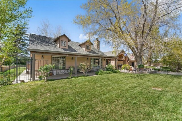 20130 Monte Vista Rd, Apple Valley, CA 92308 - rear view of house with a shingled roof, a chimney, fence, and a lawn