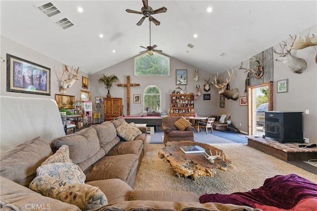 20130 Monte Vista Rd, Apple Valley, CA 92308 - carpeted living room with a wood stove, ceiling fan, visible vents, and a wealth of natural light
