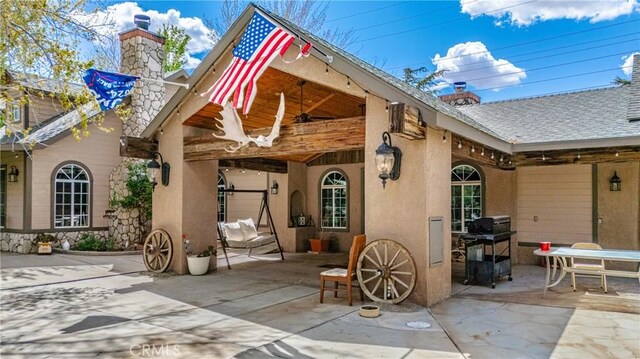 20130 Monte Vista Rd, Apple Valley, CA 92308 - rear view of property featuring stucco siding, a ceiling fan, roof with shingles, a patio area, and a chimney