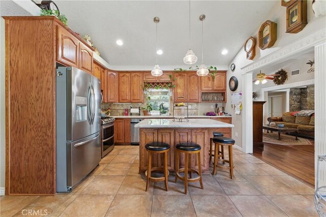 20130 Monte Vista Rd, Apple Valley, CA 92308 - kitchen featuring brown cabinets, light countertops, visible vents, and stainless steel appliances