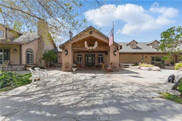 20130 Monte Vista Rd, Apple Valley, CA 92308 - rear view of house with a patio and stone siding