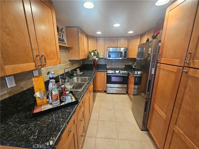 803 E Victoria St Unit 103, Carson, CA 90746 - kitchen featuring stainless steel appliances, backsplash, a sink, brown cabinetry, and recessed lighting