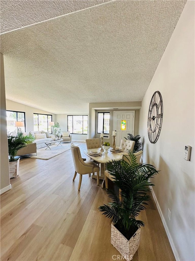 13201 El Dorado Dr Unit M9-207G, Seal Beach, CA 90740 - dining area with baseboards, light wood-style floors, and a textured ceiling