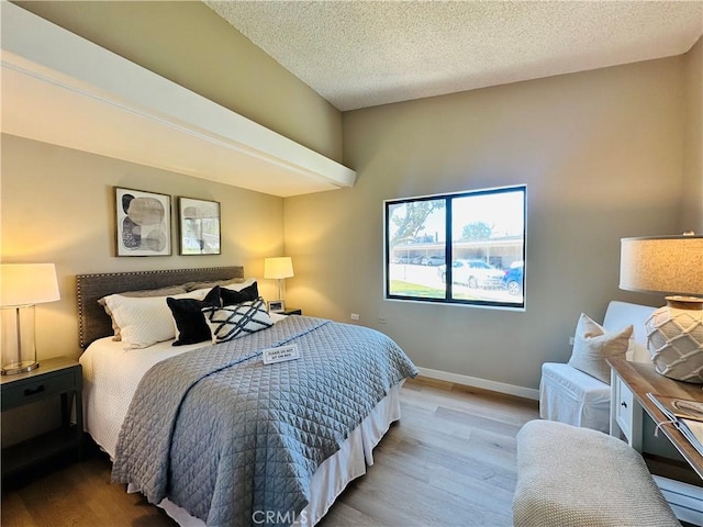 13201 El Dorado Dr Unit M9-207G, Seal Beach, CA 90740 - bedroom with baseboards, a textured ceiling, and wood finished floors