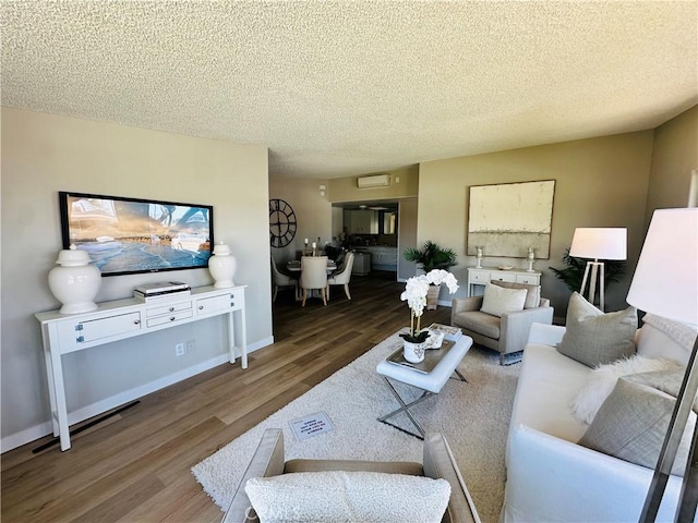 13201 El Dorado Dr Unit M9-207G, Seal Beach, CA 90740 - living area featuring a textured ceiling, baseboards, and wood finished floors