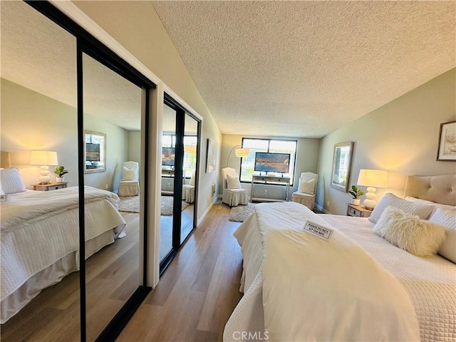 13201 El Dorado Dr Unit M9-207G, Seal Beach, CA 90740 - bedroom with a textured ceiling, wood finished floors, access to exterior, lofted ceiling, and baseboards