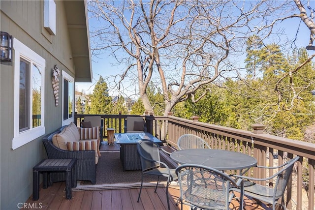 deck featuring outdoor lounge area and outdoor dining area