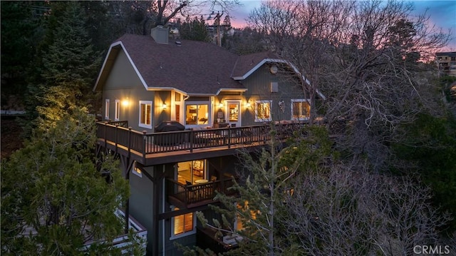 813 Brentwood Dr, Lake Arrowhead, CA 92352 - back of property at dusk with roof with shingles, a chimney, and a deck