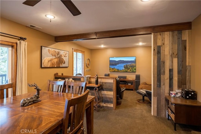 carpeted dining room featuring visible vents, ceiling fan, and a healthy amount of sunlight