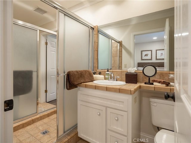 bathroom with toilet, a shower stall, and visible vents
