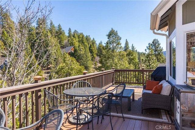 wooden deck with outdoor dining space and an outdoor living space