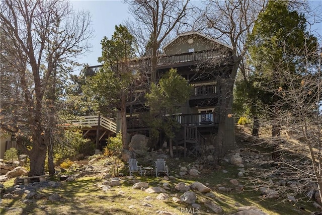 rear view of property featuring stairs