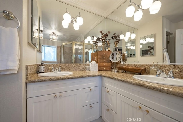 full bathroom with a sink, a shower stall, and an inviting chandelier