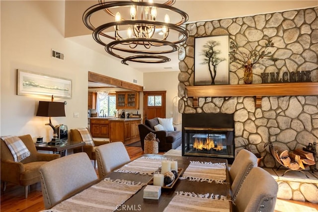813 Brentwood Dr, Lake Arrowhead, CA 92352 - living room featuring a chandelier, wood finished floors, and a stone fireplace