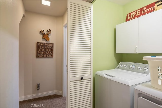 laundry room with carpet, separate washer and dryer, baseboards, and cabinet space