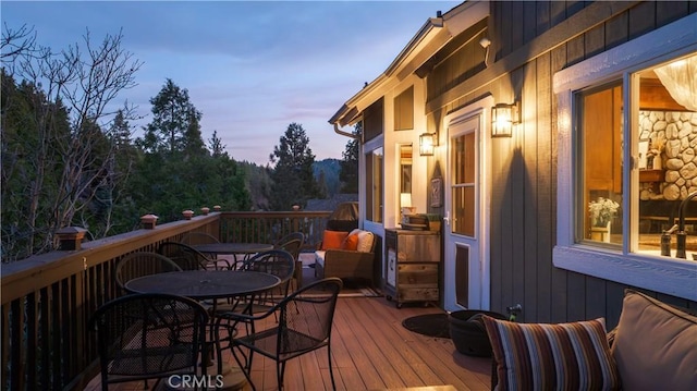 wooden terrace featuring outdoor dining space