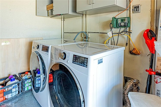 laundry room featuring cabinet space and separate washer and dryer