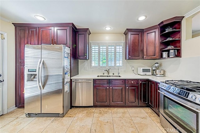 kitchen featuring appliances with stainless steel finishes, a sink, dark brown cabinets, and recessed lighting