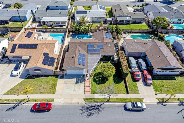 aerial perspective of suburban area featuring a pool