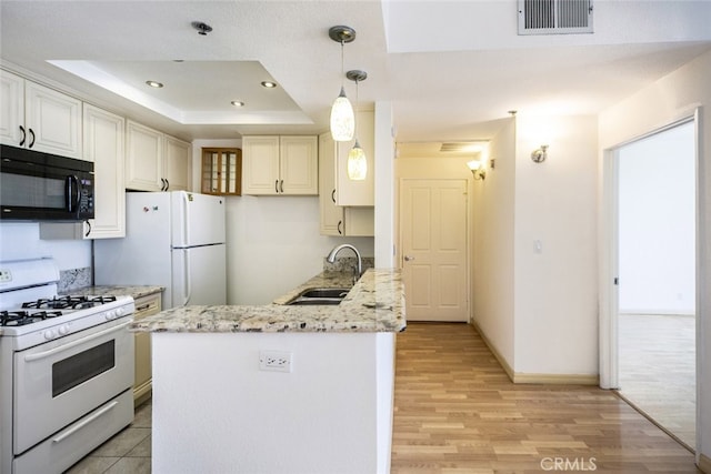 19350 Sherman Way Unit 114, Reseda, CA 91335 - kitchen with white appliances, a peninsula, visible vents, a raised ceiling, and a sink