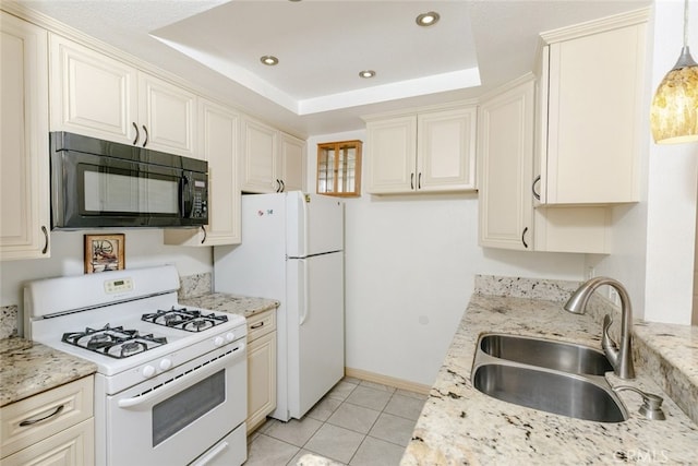 19350 Sherman Way Unit 114, Reseda, CA 91335 - kitchen with light tile patterned floors, a raised ceiling, a sink, white appliances, and cream cabinetry
