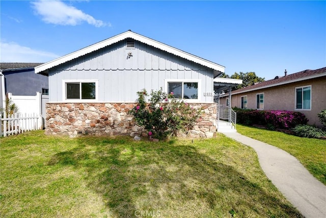6160 California Ave, Long Beach, CA 90805 - view of home's exterior with board and batten siding, a yard, fence, and stone siding