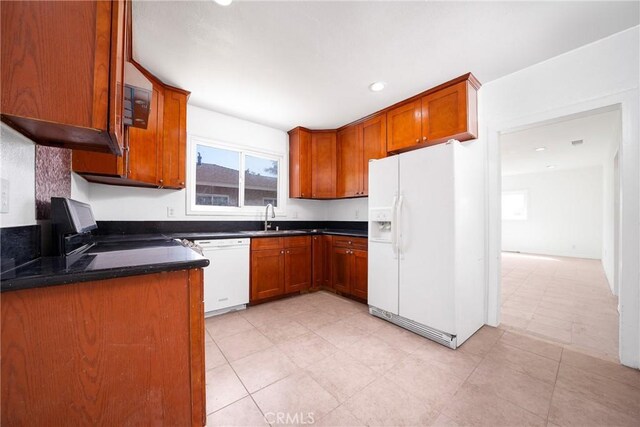 6160 California Ave, Long Beach, CA 90805 - kitchen featuring white appliances, brown cabinets, a sink, and dark countertops