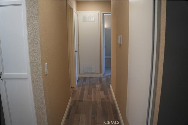 22234 S Vermont Ave Unit 203B, Torrance, CA 90502 - hallway with wood finished floors, a textured wall, and baseboards