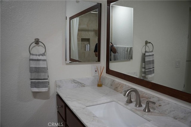 22234 S Vermont Ave Unit 203B, Torrance, CA 90502 - bathroom featuring a textured wall and vanity