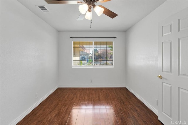 unfurnished room with ceiling fan, visible vents, baseboards, and wood finished floors