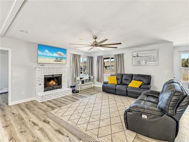 7455 Bangor Ave, Hesperia, CA 92345 - living area with a textured ceiling, ceiling fan, plenty of natural light, and wood finished floors
