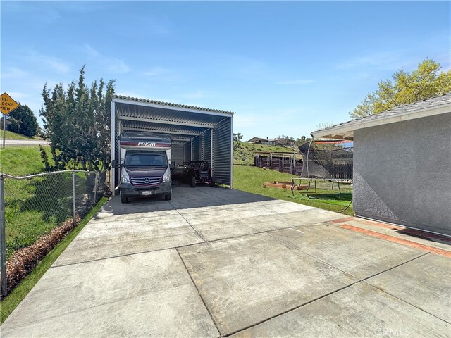 7455 Bangor Ave, Hesperia, CA 92345 - exterior space with a carport, a trampoline, fence, and concrete driveway