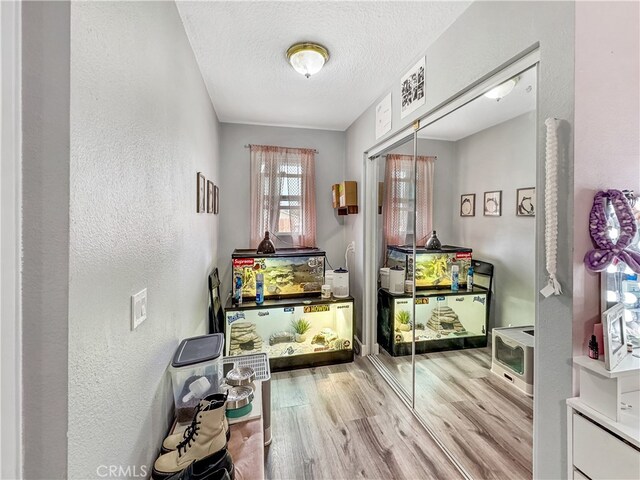 7455 Bangor Ave, Hesperia, CA 92345 - doorway to outside featuring a textured ceiling, a textured wall, and wood finished floors