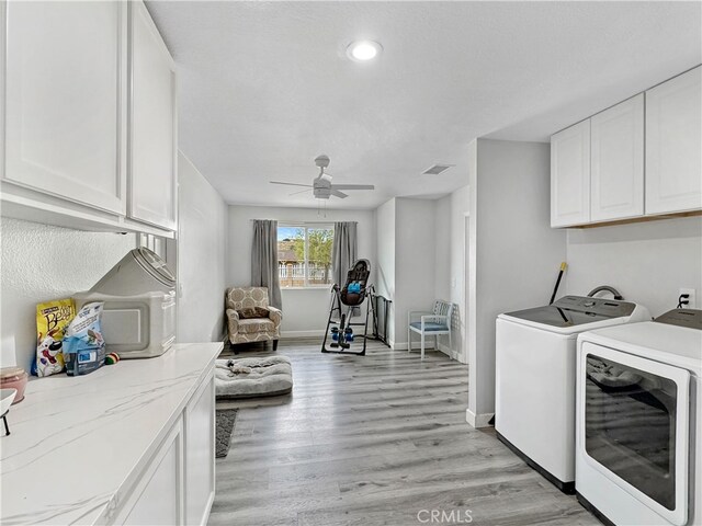 7455 Bangor Ave, Hesperia, CA 92345 - washroom with ceiling fan, visible vents, light wood-type flooring, cabinet space, and washer and clothes dryer
