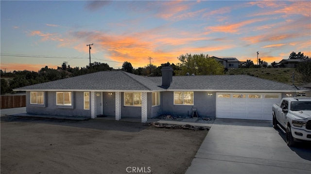 7455 Bangor Ave, Hesperia, CA 92345 - view of front facade with driveway, a chimney, and a garage