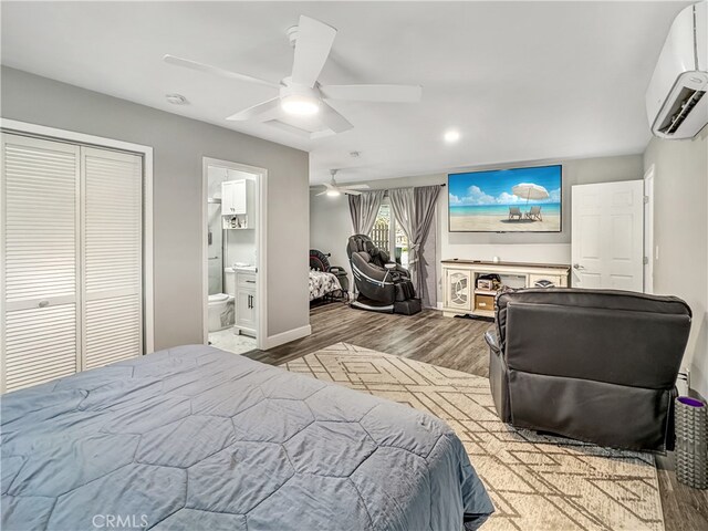 7455 Bangor Ave, Hesperia, CA 92345 - bedroom with wood finished floors, ceiling fan, an AC wall unit, recessed lighting, and connected bathroom