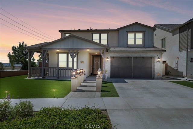 16614 Trailblazer Ave, Chino, CA 91708 - traditional-style home with a porch, a lawn, a garage, board and batten siding, and driveway