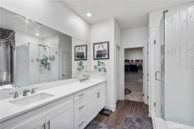 16614 Trailblazer Ave, Chino, CA 91708 - bathroom with a sink, a walk in closet, a stall shower, and wood finished floors