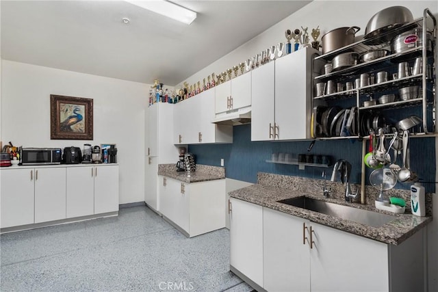 16614 Trailblazer Ave, Chino, CA 91708 - kitchen featuring stone counters, white cabinetry, light speckled floor, stainless steel microwave, and a sink