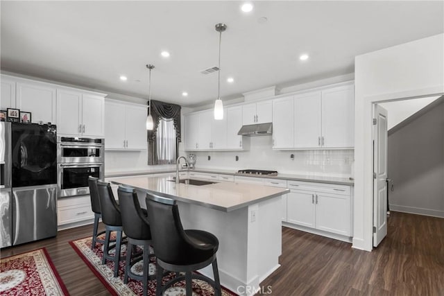 16614 Trailblazer Ave, Chino, CA 91708 - kitchen with a sink, light countertops, under cabinet range hood, white cabinetry, and stainless steel appliances