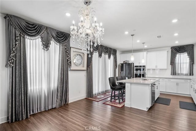 16614 Trailblazer Ave, Chino, CA 91708 - kitchen with recessed lighting, an island with sink, light countertops, and appliances with stainless steel finishes