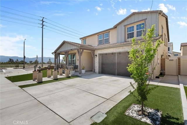 16614 Trailblazer Ave, Chino, CA 91708 - view of front facade featuring a garage, stucco siding, fence, a mountain view, and concrete driveway