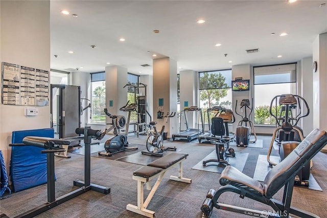 exercise room featuring visible vents, recessed lighting, and carpet