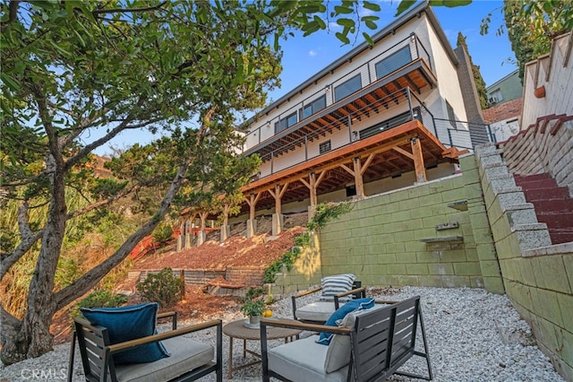 rear view of property with a patio area, stairway, and a deck